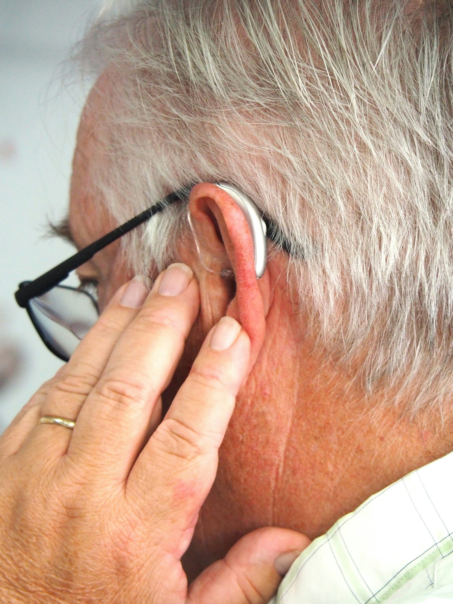 A man wearing glasses and a pair of headphones